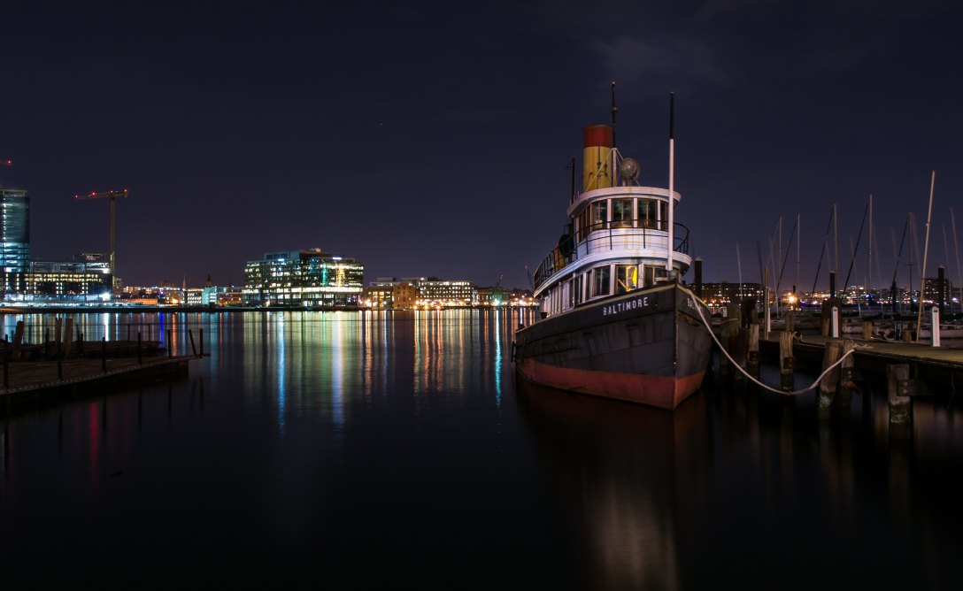 Baltimore harbor at night. Photo by Bob Burkhard on Unsplash.