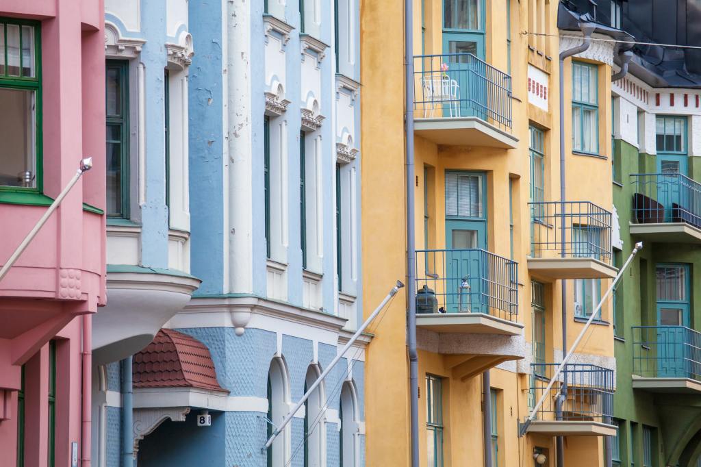 Photo of three-story, pastel-colored buildings with empty balconies by Tapio Haaja on Unsplash